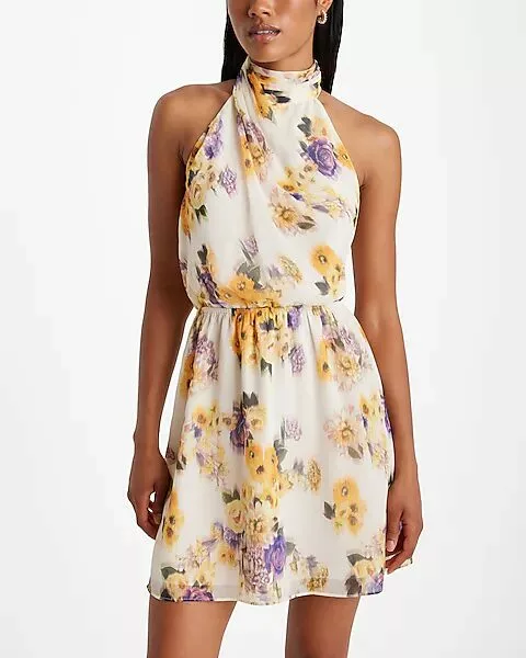 Office Style Diary - Woman wearing a sleeveless, halter-neck dress with a floral print in yellow and purple hues, showcasing a chic and elegant outfit perfect for both casual and semi-formal occasions.